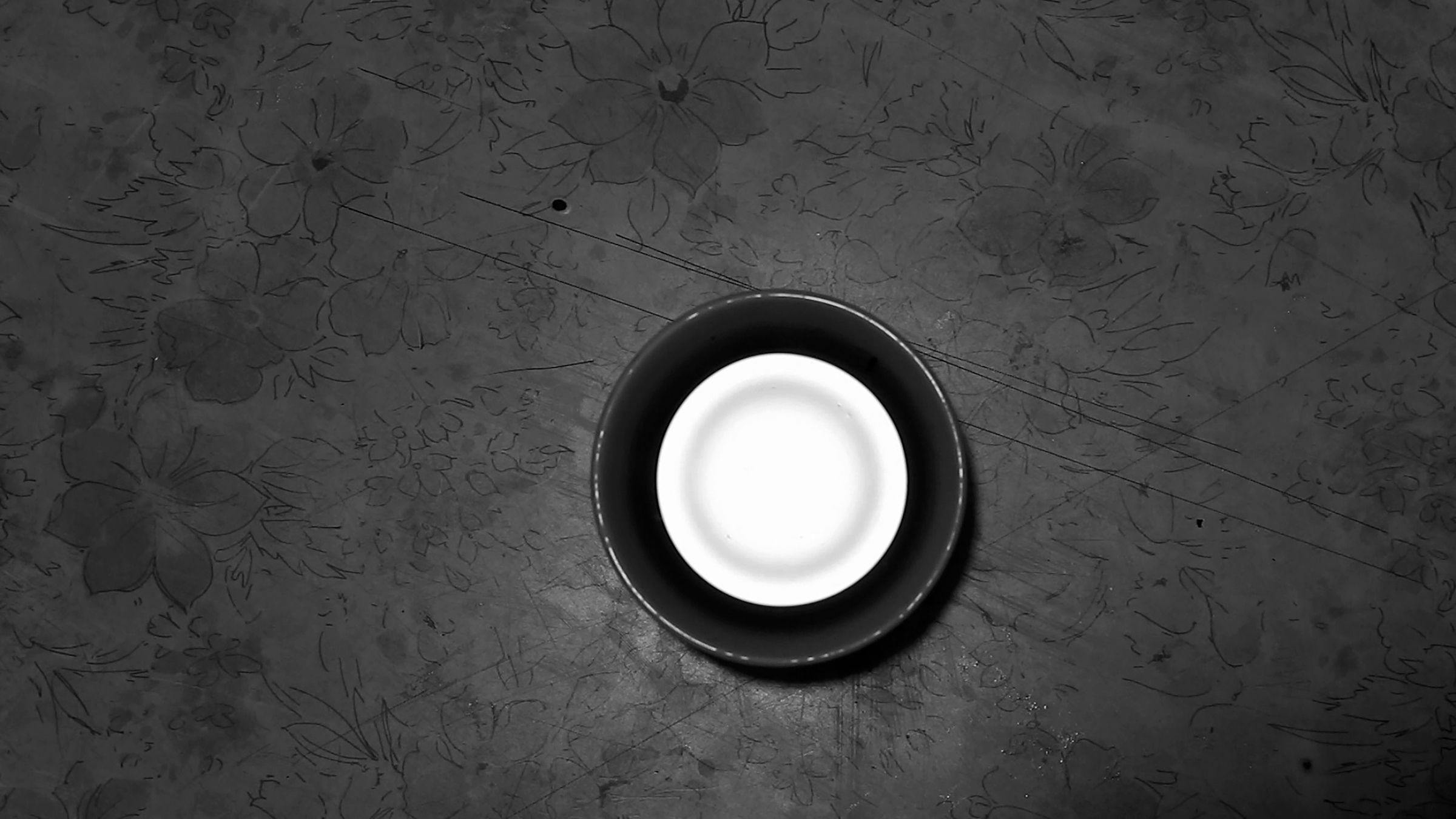 a black and white image of a cup with a lid