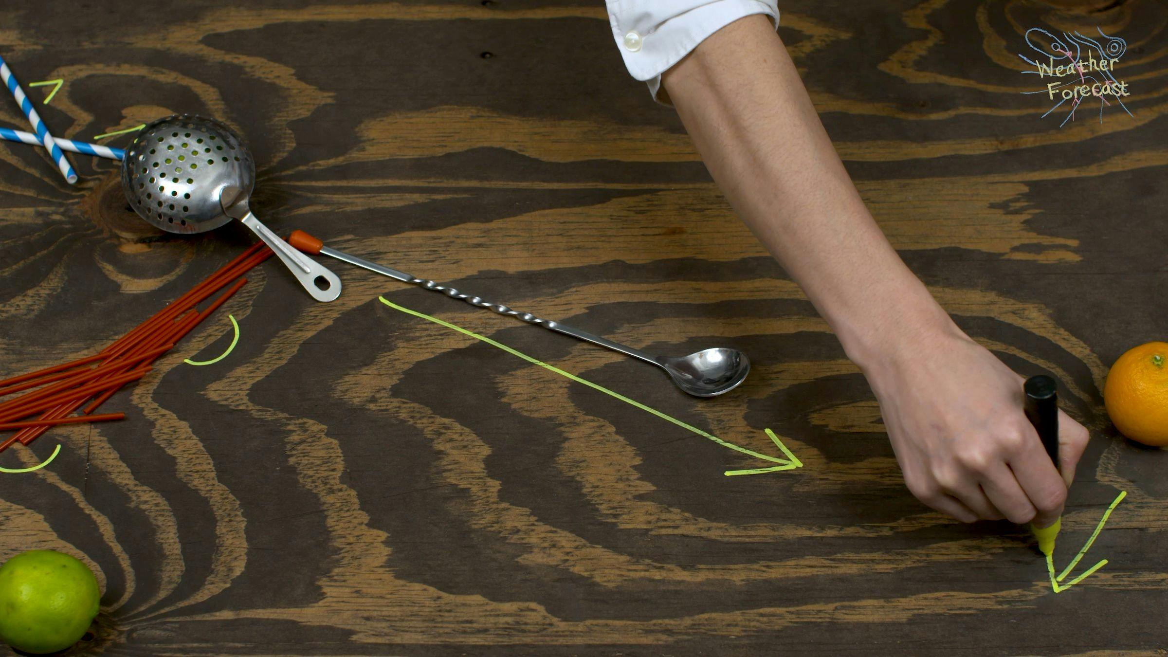 the artist is drawing yellow arrows on a wooden surface